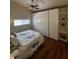 Bedroom with hardwood floors, ceiling fan, and built-in wardrobe/shelving storage at 6235 17Th N Ave, St Petersburg, FL 33710