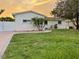 The house has a beautiful lawn and a winding brick border around a palm tree at 6235 17Th N Ave, St Petersburg, FL 33710