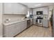 Modern kitchen with stainless steel appliances, granite countertops, and sleek gray cabinetry at 6235 17Th N Ave, St Petersburg, FL 33710