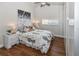 Bright main bedroom with artwork, wood floors, and a ceiling fan at 6235 17Th N Ave, St Petersburg, FL 33710