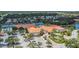 Aerial view of a community center with a pool, tennis courts, parking and a red tile roof at 6315 43Rd E Ct, Sarasota, FL 34243