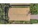 Aerial view of a well maintained tile roof surrounded by lush, mature trees and landscaping at 6315 43Rd E Ct, Sarasota, FL 34243