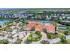 Community center features tennis courts, community pool, lush landscaping, and ample parking at 6315 43Rd E Ct, Sarasota, FL 34243