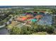 Aerial view of community center featuring a pool, tennis courts, pickleball courts, and clubhouse at 6315 43Rd E Ct, Sarasota, FL 34243