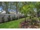 Lush backyard featuring a well-maintained lawn, privacy fence, and mature landscaping at 6315 43Rd E Ct, Sarasota, FL 34243