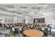 Elegant ballroom with stage, tables, seating, and coffered ceilings at 6315 43Rd E Ct, Sarasota, FL 34243