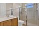 Bathroom with wood cabinet vanity and tile enclosed glass shower providing bright and comfortable space at 6315 43Rd E Ct, Sarasota, FL 34243