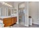 Bright bathroom featuring a vanity with wood cabinets, a glass shower, and great lighting throughout at 6315 43Rd E Ct, Sarasota, FL 34243