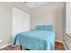 Bedroom featuring a blue comforter and wood flooring creating a cozy retreat at 6315 43Rd E Ct, Sarasota, FL 34243