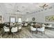 Well-appointed clubhouse features tables and chairs with modern decor and neutral tones for relaxing and socializing at 6315 43Rd E Ct, Sarasota, FL 34243