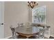 Cozy dining nook features a modern chandelier and a window with views of palm trees at 6315 43Rd E Ct, Sarasota, FL 34243
