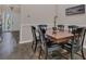 Traditional dining room with dark wood table, six chairs, and wood flooring provides comfortable gathering space at 6315 43Rd E Ct, Sarasota, FL 34243