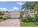 Charming home featuring a paved driveway, lush landscaping, a two-car garage, and well-maintained lawn at 6315 43Rd E Ct, Sarasota, FL 34243