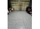 Spacious garage featuring epoxy flooring and ample storage space with an overhead door at 6315 43Rd E Ct, Sarasota, FL 34243