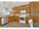Bright kitchen with stainless steel dishwasher, granite countertops, and wooden cabinets at 6315 43Rd E Ct, Sarasota, FL 34243