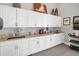 Clean kitchen area featuring white cabinets, granite countertops, and stainless steel appliances for convenience at 6315 43Rd E Ct, Sarasota, FL 34243