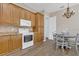 Well-lit kitchen featuring ample cabinets, granite countertops, and a casual dining nook at 6315 43Rd E Ct, Sarasota, FL 34243