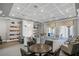 Bright community lounge with coffered ceilings, fireplace, library shelves and comfortable chairs at 6315 43Rd E Ct, Sarasota, FL 34243
