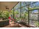 Screened patio featuring comfortable seating, a ceiling fan, and a view of the backyard at 6315 43Rd E Ct, Sarasota, FL 34243