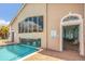 Community pool with waterfalls, large windows, pool rules, and easy access to the building's interior at 6315 43Rd E Ct, Sarasota, FL 34243