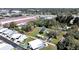 Aerial view of property in a well-connected community with a spacious lot, outlined in red, near a busy commercial area at 6673 146Th N Ave, Clearwater, FL 33764