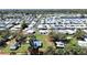 Expansive aerial view of a property with a large yard, outlined in red, and surrounded by a vibrant community at 6673 146Th N Ave, Clearwater, FL 33764