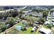 An aerial view of a property with a large lot, outlined in red, showing multiple structures and mature trees at 6673 146Th N Ave, Clearwater, FL 33764