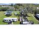Aerial view of the property showing multiple sheds, homes, and RVs in a wooded area at 6673 146Th N Ave, Clearwater, FL 33764