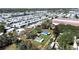 Aerial view of a property with mature trees, situated in a community setting with a clear property outline in red at 6673 146Th N Ave, Clearwater, FL 33764