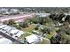 The aerial shot captures a mobile home park and mature trees, with a white fence at 6673 146Th N Ave, Clearwater, FL 33764