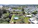 Aerial view of a spacious property outlined in red, with a mix of trees and structures, set within a lively neighborhood at 6673 146Th N Ave, Clearwater, FL 33764