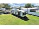 Exterior shot of the Wildwood Trailer in a well-maintained grassy area on a sunny day at 6673 146Th N Ave, Clearwater, FL 33764
