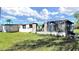 Exterior view of the damaged home with lawn on a partly cloudy day at 6673 146Th N Ave, Clearwater, FL 33764