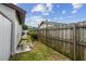 Side yard featuring a wooden fence, landscaping and pool equipment at 6903 Cedar Ridge N Dr, Pinellas Park, FL 33781