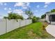 Large, grassy backyard with a privacy fence and lush landscaping, perfect for outdoor activities at 6903 Cedar Ridge N Dr, Pinellas Park, FL 33781