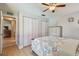 Bedroom with light wood floors, built-in closet and neutral walls at 6903 Cedar Ridge N Dr, Pinellas Park, FL 33781