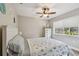 Bedroom with ceiling fan, nautical decor, and natural light from the window at 6903 Cedar Ridge N Dr, Pinellas Park, FL 33781