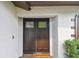 Elegant double front doors with decorative glass panels, complemented by a textured exterior and a welcoming entrance at 6903 Cedar Ridge N Dr, Pinellas Park, FL 33781