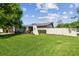 Well-manicured lawn frames this single-story home, featuring a privacy fence and trimmed hedges for enhanced curb appeal at 6903 Cedar Ridge N Dr, Pinellas Park, FL 33781
