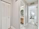 Hallway leading to a bathroom and bedroom featuring neutral paint and tile flooring at 6903 Cedar Ridge N Dr, Pinellas Park, FL 33781