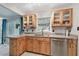 Kitchen with stainless steel dishwasher and natural wood cabinets at 6903 Cedar Ridge N Dr, Pinellas Park, FL 33781