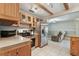 Kitchen featuring stainless steel appliances and natural wood cabinetry at 6903 Cedar Ridge N Dr, Pinellas Park, FL 33781