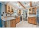 Spacious kitchen with natural wood cabinets, beams, and stainless steel appliances at 6903 Cedar Ridge N Dr, Pinellas Park, FL 33781