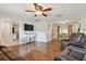 Cozy living room with hardwood floors, ceiling fan, and comfortable leather seating at 6903 Cedar Ridge N Dr, Pinellas Park, FL 33781