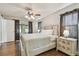 Sunlit main bedroom with hardwood floors, neutral walls, and a decorative ceiling fan at 6903 Cedar Ridge N Dr, Pinellas Park, FL 33781