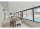 Enclosed patio area featuring a view of the pool area, seating, and wall-mounted TV at 6903 Cedar Ridge N Dr, Pinellas Park, FL 33781