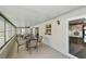 Enclosed patio with view of the pool, seating, and access to the home's interior at 6903 Cedar Ridge N Dr, Pinellas Park, FL 33781