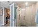Modern bathroom with a glass shower enclosure and neutral tile walls at 700 Beach Ne Dr # 704, St Petersburg, FL 33701
