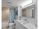 Bright and airy bathroom with a shower and bath, plus a modern vanity with a large mirror at 700 Beach Ne Dr # 704, St Petersburg, FL 33701
