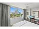 Bright bedroom with scenic city views, a ceiling fan, and TV at 700 Beach Ne Dr # 704, St Petersburg, FL 33701
